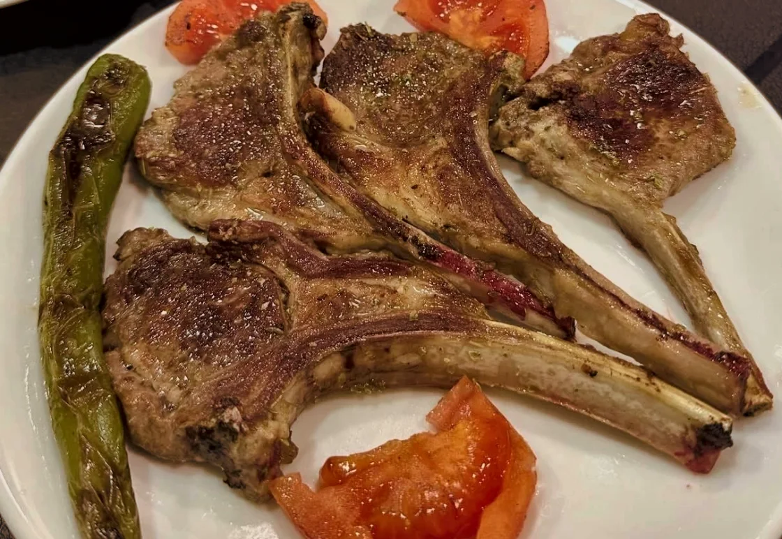 Izgara kuzu pirzola, közlenmiş biber ve domates